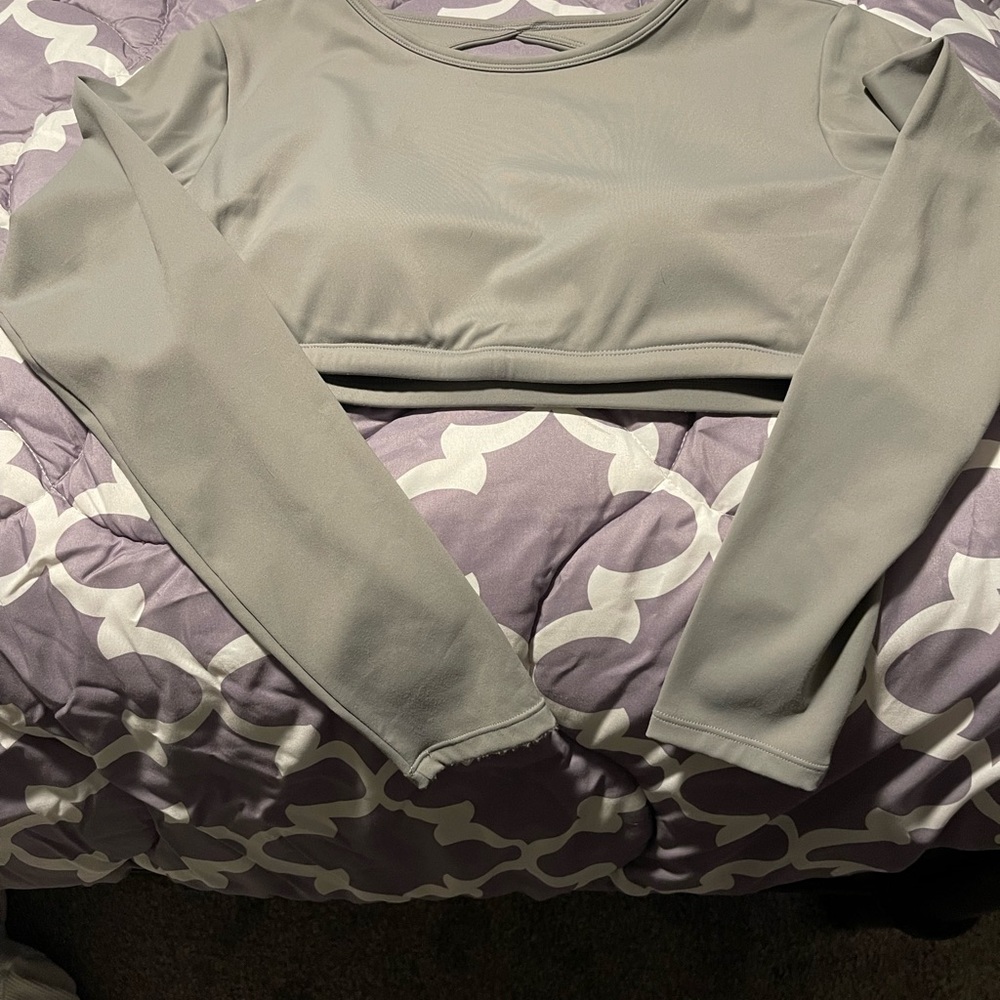 Open back, cropped, long sleeve gym top with thumb holes. Runs small